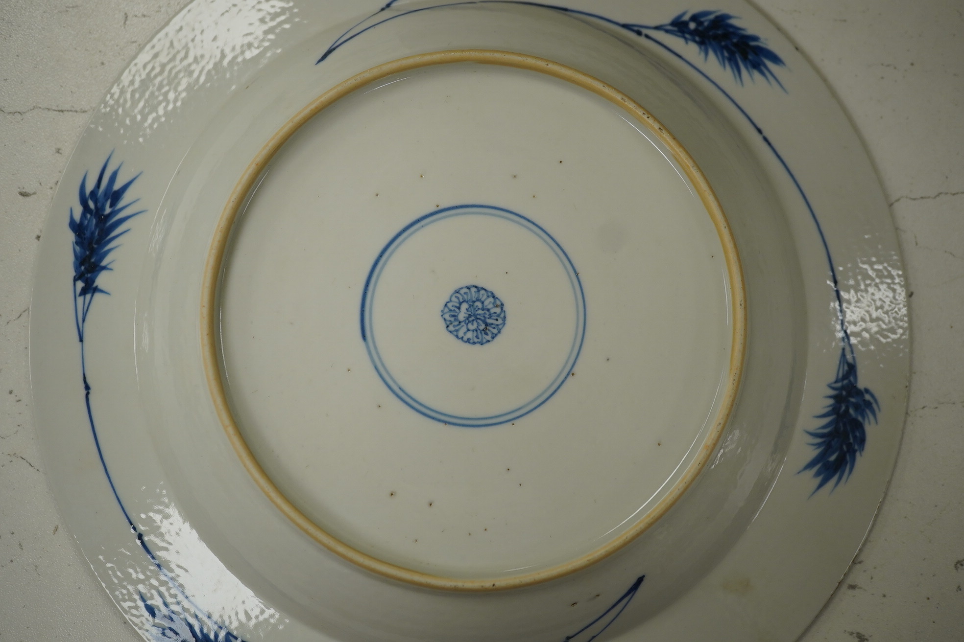 A Chinese powder blue plate, possibly Kangxi, with figurative central decoration, 22.5cm diameter. Condition - good